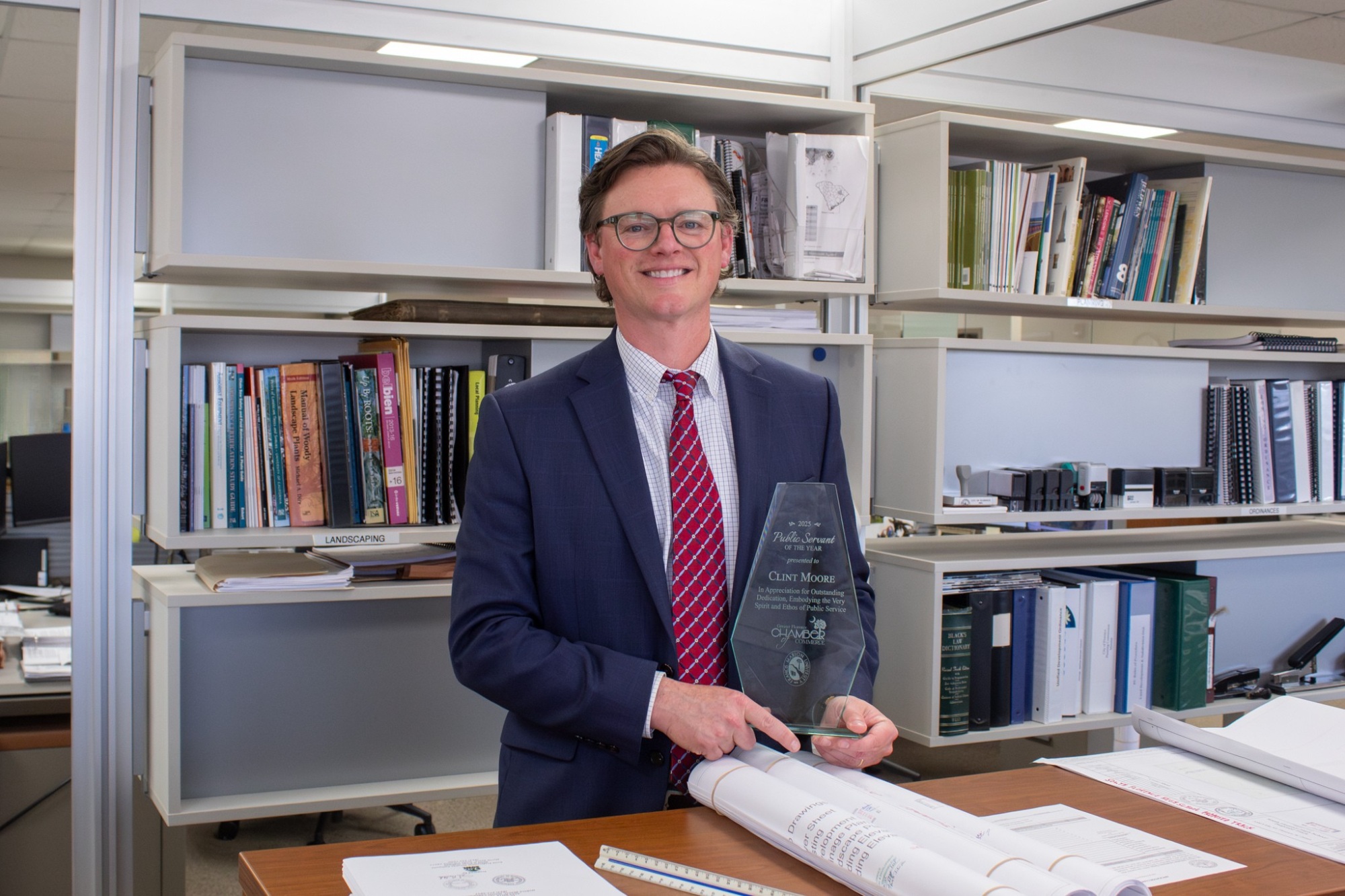 Clint Moore pictures with his Public Servant of the Year Award