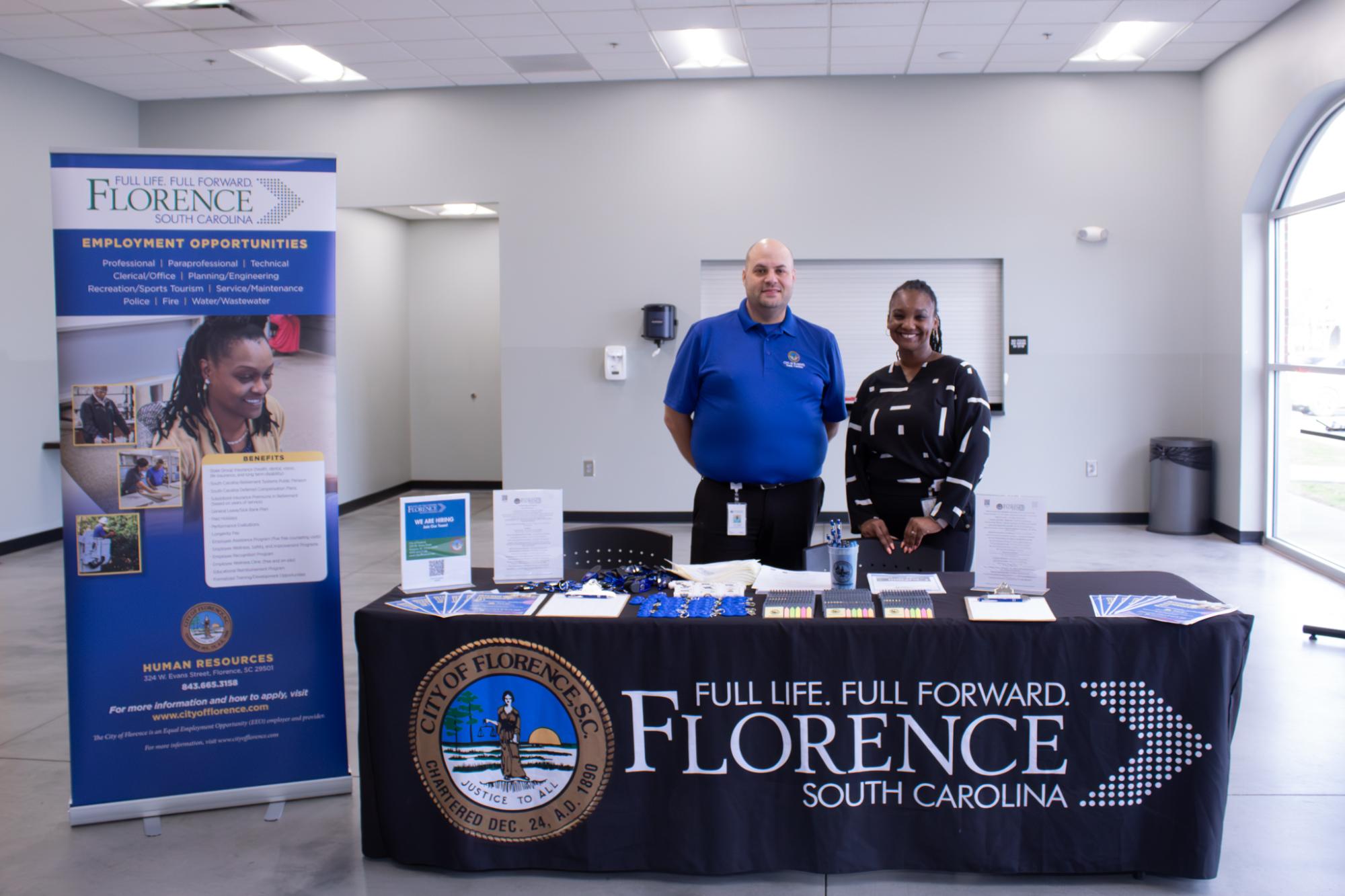 HR department behind sign up table at march 2025 hiring event
